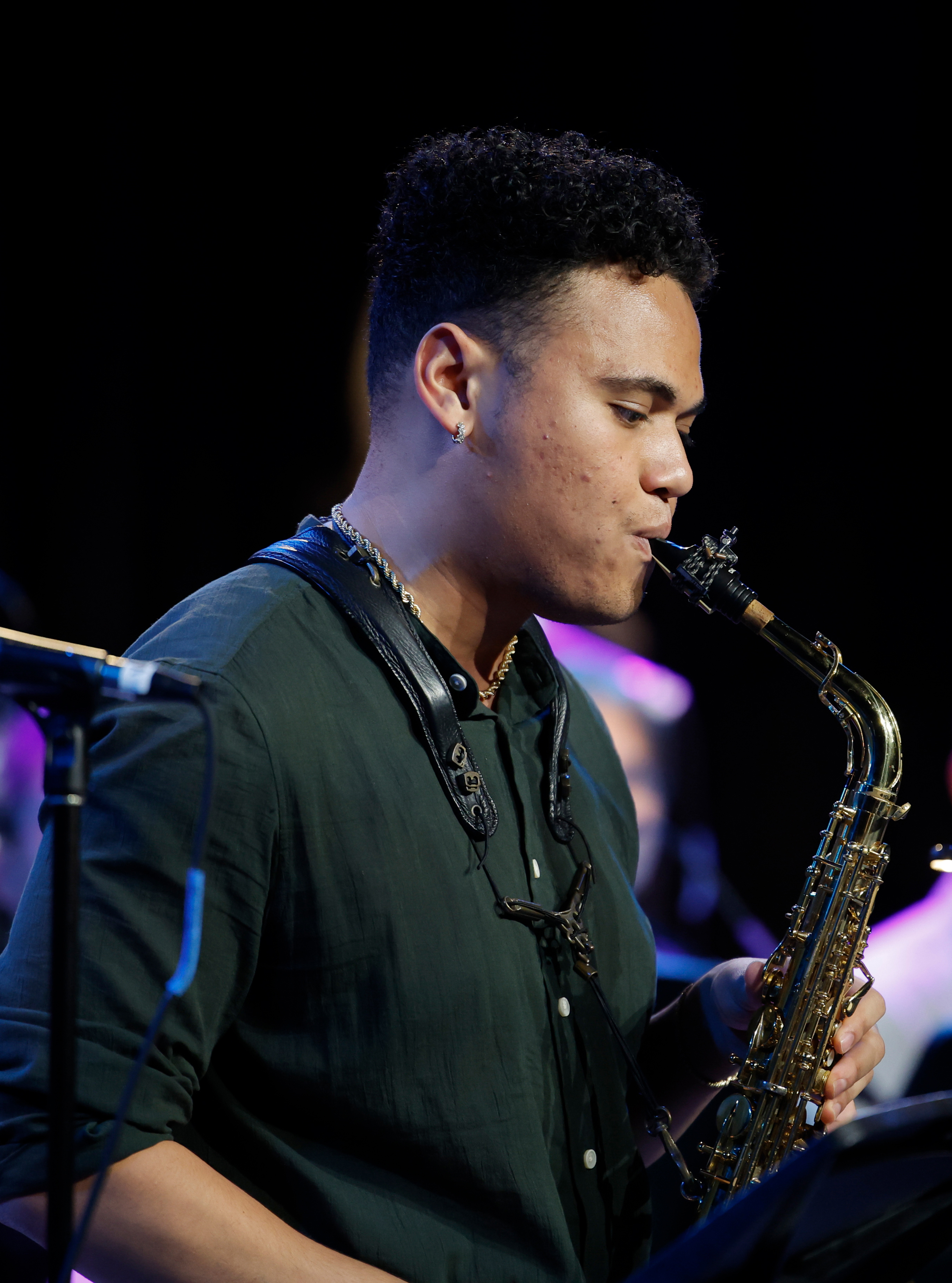 DMA student Ennis Harris (MM '22) performs a saxophone solo during a performance of his original orchestral jazz composition with the Thornton Jazz Orchestra at USC's Carson Soundstage.