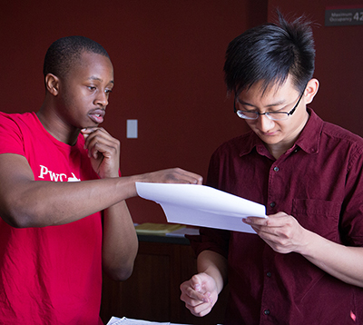 Acoounting students discuss tax documents.